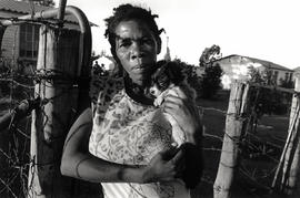 Woman with small dog in front of her house in Eureka, the coloured township of Burgersdorp, a sma...