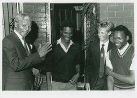 Nelson Mandela with 3 school-boys, soon after his release.