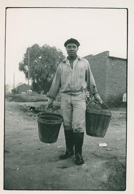Municipal worker carrying buckets for work