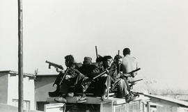 Members of the riot police (soldiers) with guns on top of a police vehicle in one of the township...