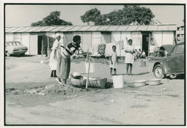 Women fill buckets from communal tap