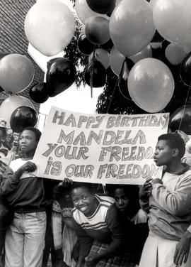 Happy birthday Mandela. Your freedom is our freedom - children with balloons to celebrate Mandela...