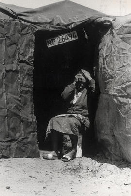 Black woman  in the door of her little house in Crossroads, a large squatter camp in Cape Town