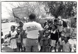 Member of the Brits Action Committee speak to some children of Oukasie, outside one of the people...