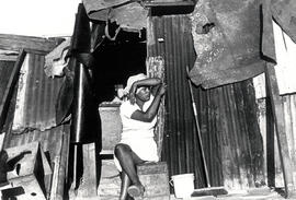 Black woman in front of her shack in Crossroads, one of Cape Town's squatter camps