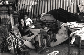 Ms Lorraine Jansen and her children sleep in the open veld after their house has been broken down...