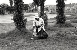 One of the first female municipal street cleaners in a Soweto park