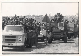 Soldiers watch the funeral of a police victim in Pimville, Soweto
