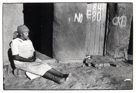 Woman rests outside her house in Umbulwane near Ladysmith, Natal - threatened with forced removal