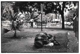 Unemployed woman sleeping in Joubert Park