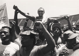 COSATU president Elijah Barayi on the shoulders of some union members at a workers rally