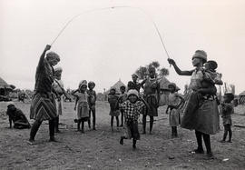 Women and children playing in a San village in North-East Namibia