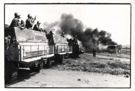 SADF troops watch a bus burn in Soweto. Johannesburg