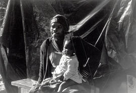 Mother and child in front of their tent 'house' in Crossroads, one of Cape Town's squatter camps