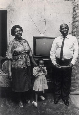 Priscilla Biyana at home, with husband and child