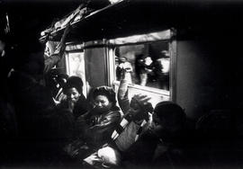 Black women during an informal church service in the train bringing them to and from their work, ...