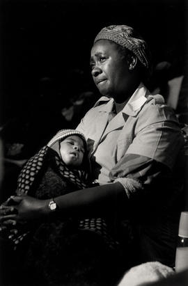 Woman with child at a tea party of the Detainees Parents Support Committee (DPSC)