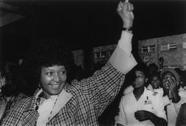 Winnie Mandela greets the crowd outside Tygerberg Hospital after a visit to her husband undergpoi...