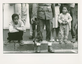 Children behind a soldier at the opening of Parliament in Cape Town