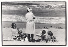 White family and domestic worker on the beach in Plettenberg Bay
