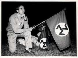 AWB supporter listens to its leader Eugene TerreBlanche while holding the swastika-like flag of t...