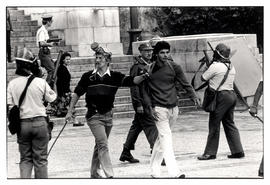 Armed policeman arrests a student during an anti-apartheid protest at the University of Cape Town...