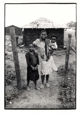 Woman with two children in Ntambana, a relocation area near Empangeni in Natal