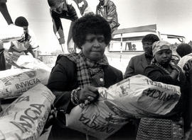 Winnie Mandela delivers maize meal to the pensioners of Brandfort, where she endured eight years ...