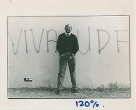 Murphy Morobe standing in front of graffiti