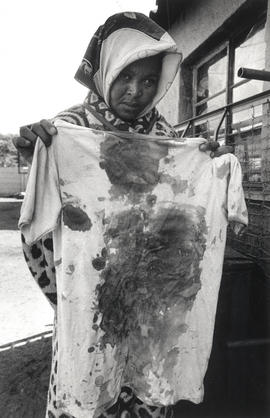 Mrs Mazibuko with the blood stained t-shirt of her son, who was shot in the back and killed by th...