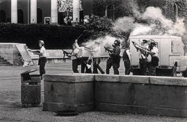 Policemen shooting teargas at demonstrating students of the University of Cape Town