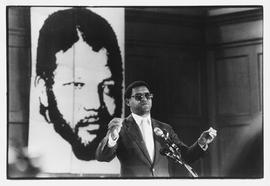Rev. Allan Boesak addressing a meeting in Cape Town, with Nelson Mandela's portrait behind him