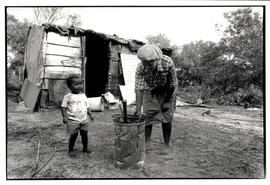 Woman and child in front of shack in Brown's Farm, Khayelitsha