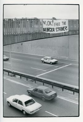 Banner "Vlok! Free the Hunger strikers" across a highway bridge