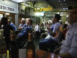 Patrons at a pub watching an international rugby match. Durban, KwaZulu Natal