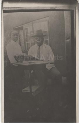S T Plaatje, wearing hat, child and typewriter