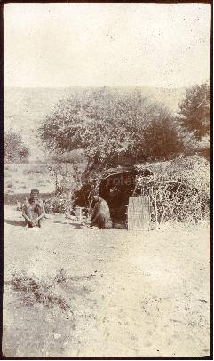 Two Bushmen sitting next to a Hut, Langerbergen