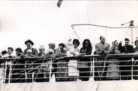 People waving from board a ship