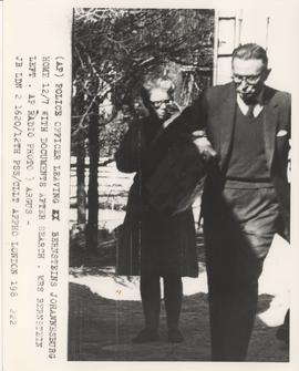 Police officer leaving the Bernstein's Johannesburg home with documents after a search on the 12 ...